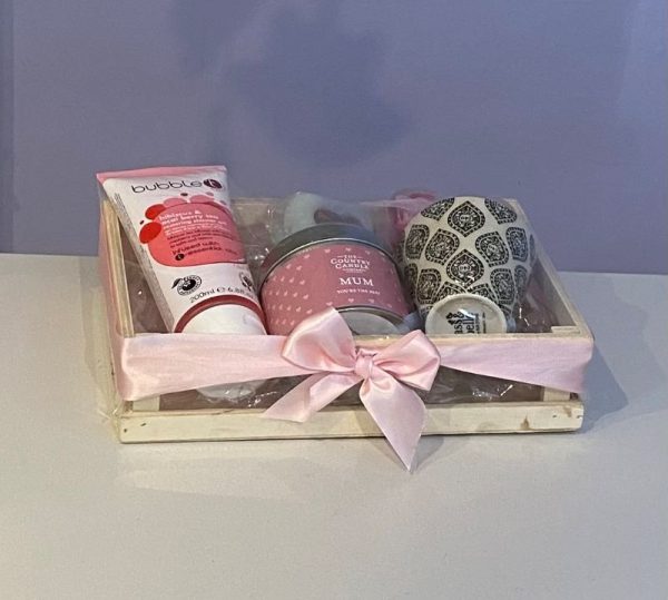 Mother's Day pampering gift. Wooden storage crate filled with scented candle, shower gel, soap roses, soap cake and mini plant pot